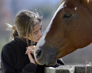 Girl kissing horse's nose