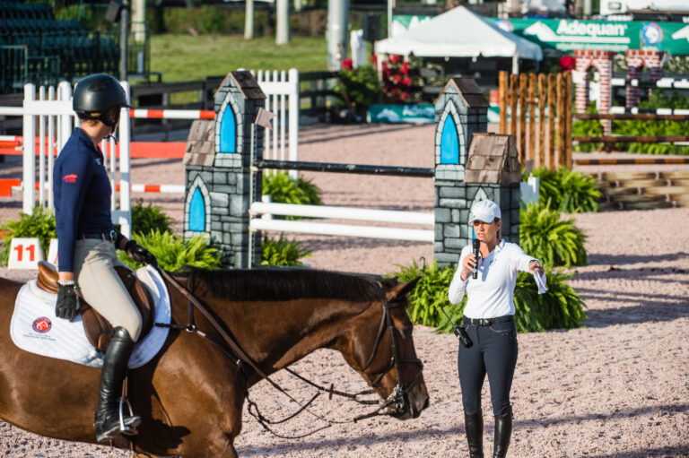 After finishing her jumping course with Baricello, Emma Marlowe receives feedback from Laura Kraut.